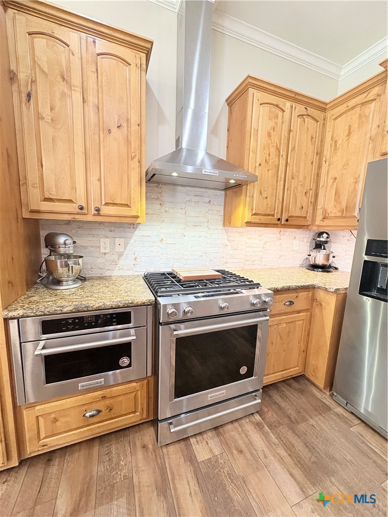949 Abrameit Road Goliad, TX 77963 - Photo 33 of 48 a kitchen with granite countertop a stove a sink and a microwave