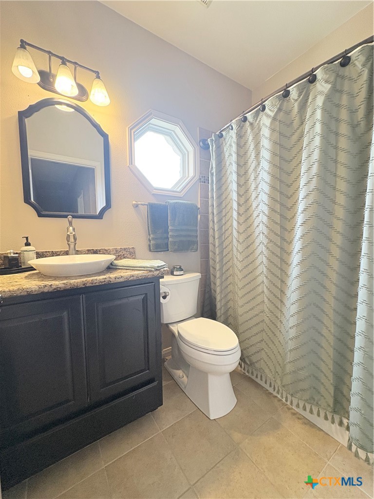 949 Abrameit Road Goliad, TX 77963 - Photo 36 of 48 a bathroom with a toilet sink vanity granite and mirror