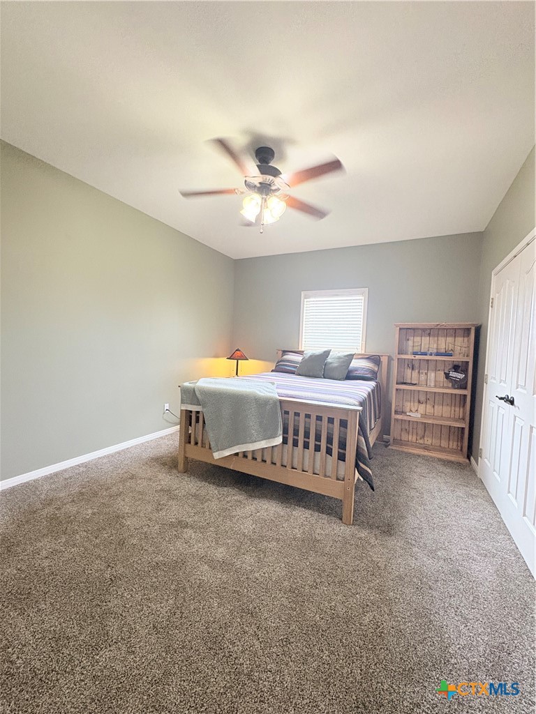 949 Abrameit Road Goliad, TX 77963 - Photo 37 of 48 a bedroom with furniture and a chandelier