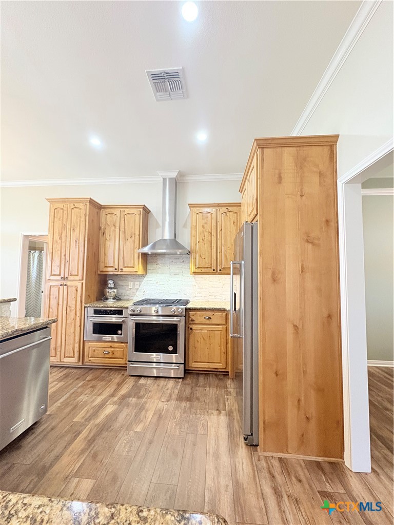 949 Abrameit Road Goliad, TX 77963 - Photo 45 of 48 a kitchen with stainless steel appliances a refrigerator and wooden floor