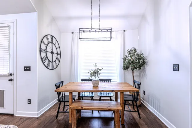 a view of a dining room with furniture and wooden floor