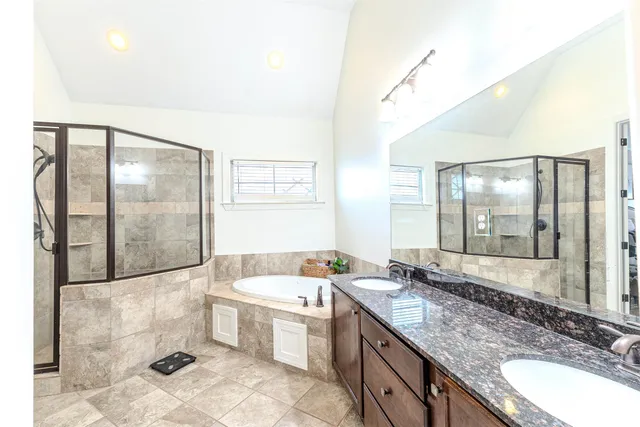 a bathroom with a granite countertop sink a toilet and a mirror