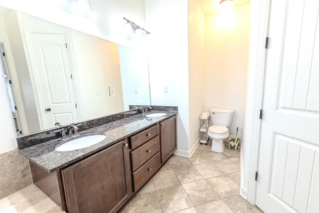 a bathroom with a granite countertop bathtub shower sink and mirror