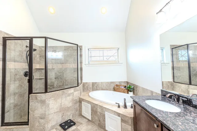 a bathroom with a bathtub sink and mirror