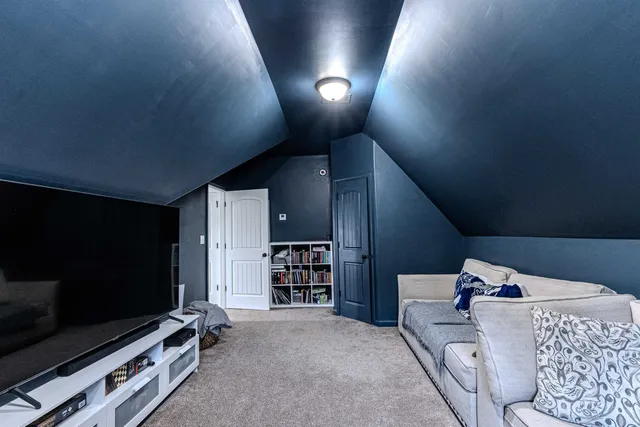 a view of a house with a yard potted plants and large tree