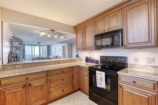 a kitchen with stainless steel appliances granite countertop a refrigerator and a stove