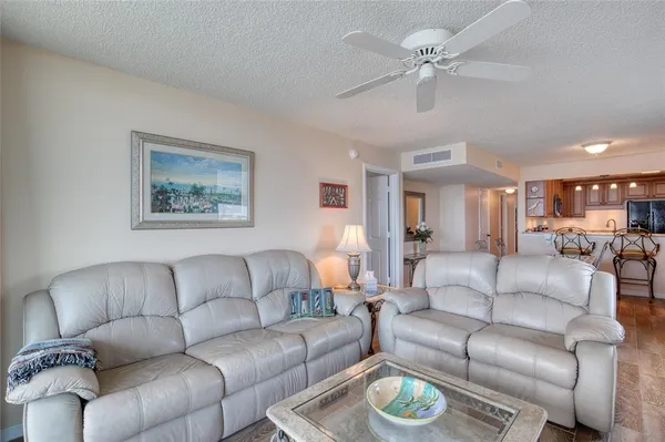 a bedroom with a bed and a flat tv screen on the dresser