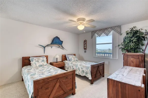a bedroom with double bed and a chandelier