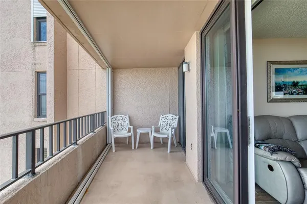 a view of balcony with furniture