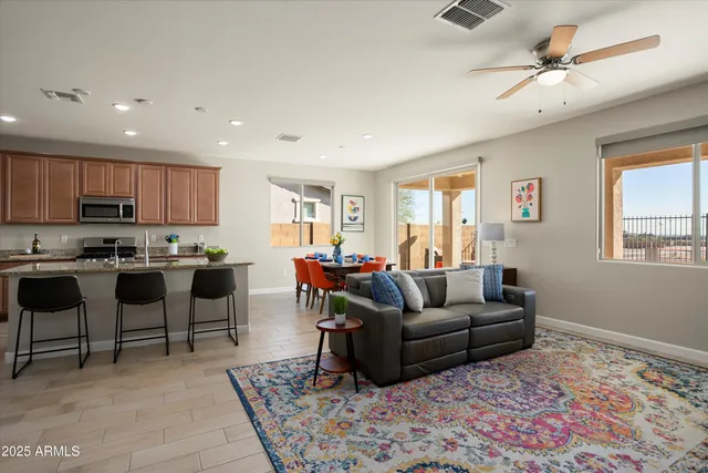 a dining room with furniture and a floor to ceiling window