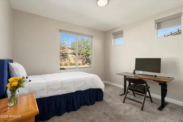 a bedroom with a bed and a mirror