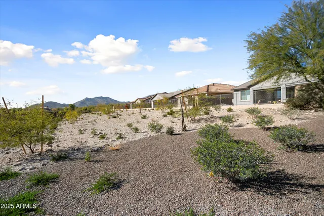 a view of a patio with a dining table and chairs with wooden floor