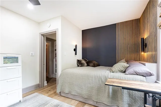 a bedroom with a bed and wooden floor
