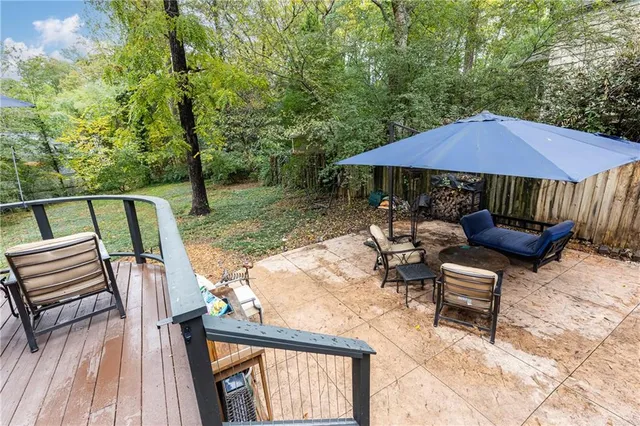a view of backyard with outdoor seating a patio and plants