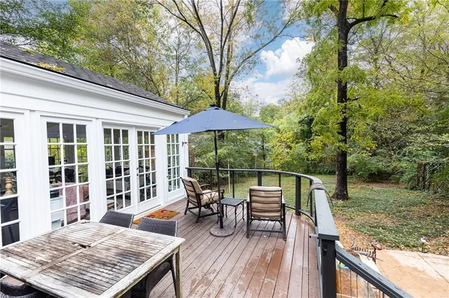 a view of balcony with wooden floor and outdoor seating