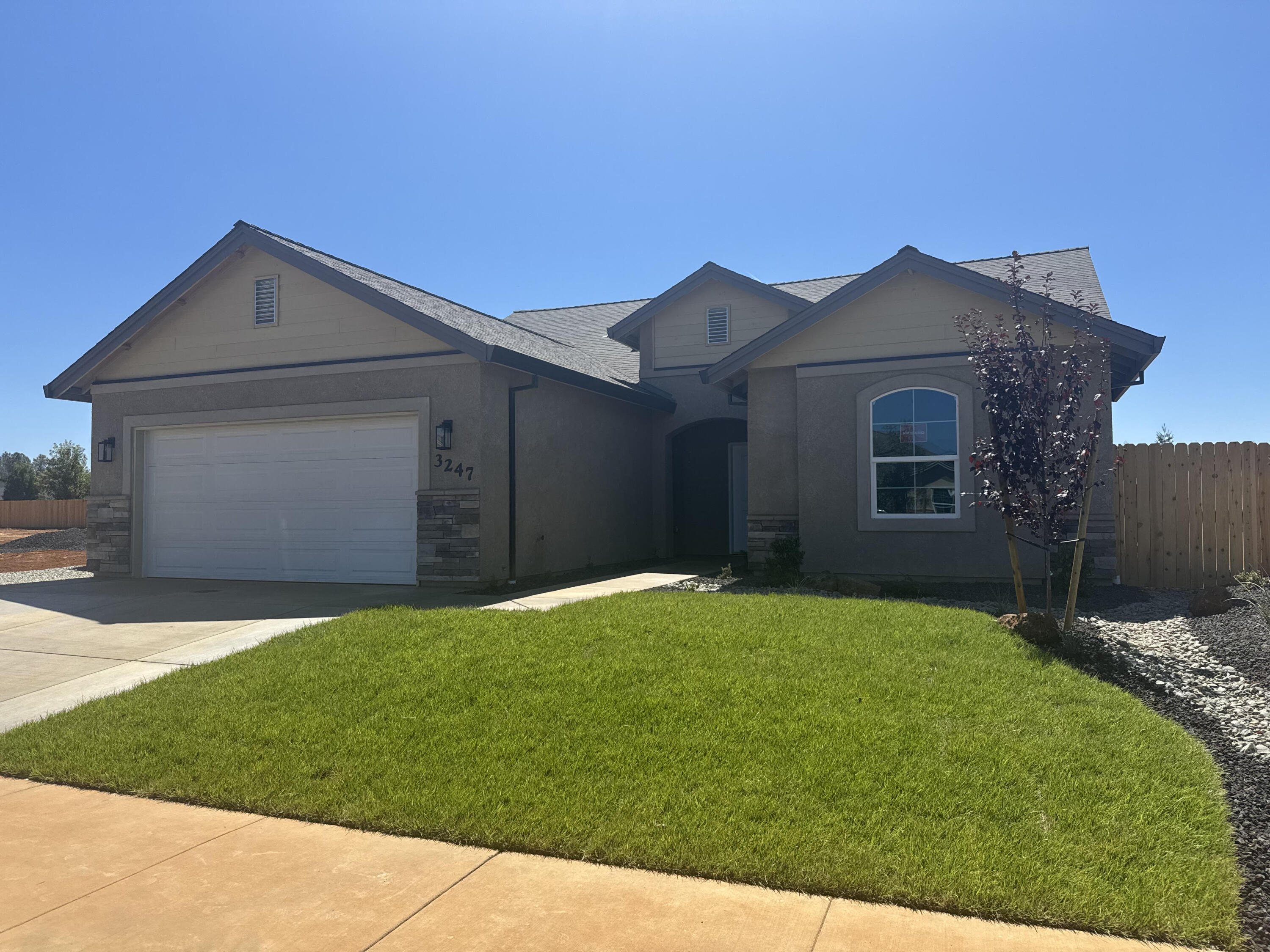 3247 Lower Lane Redding, CA 96002 - Photo 2 of 3 a front view of a house with a yard and garage