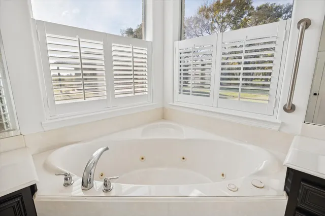 a white bath tub sitting next to a window