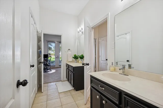 a spacious bathroom with a granite countertop sink a mirror and a