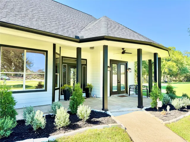 a view of a house with potted plants