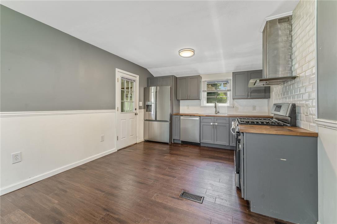 1331 Ridge Trail Easton, PA 18040 - Photo 4 of 22 Functional kitchen offering sleek stainless steel appliances, dark wood flooring, and ample cabinetry for storage.