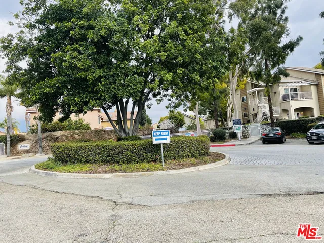 a white house that has a tree in front of it
