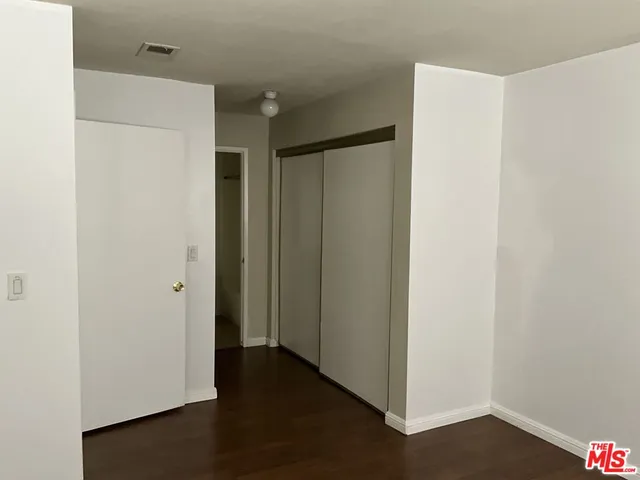 a view of hallway with wooden floor