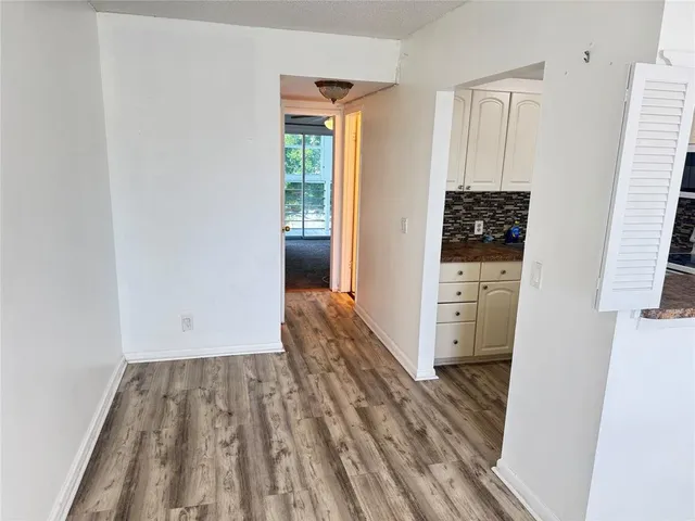 a view of a bedroom with wooden floor and furniture