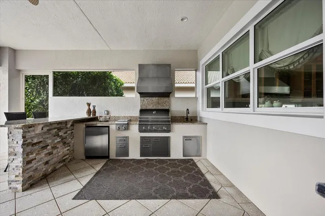 an aerial view of a city with lots of residential buildings and ocean view in back