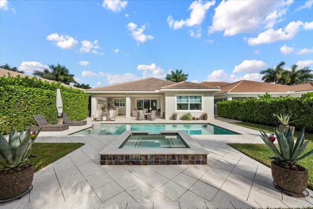 a living room with fireplace furniture and a large window
