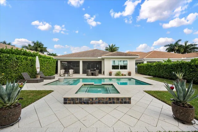 a view of a swimming pool with an outdoor seating