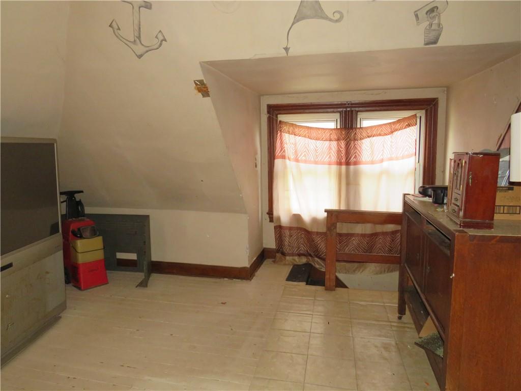 1214 Amanda Street Pittsburgh, PA 15210 - Photo 18 of 19 a living room with furniture a window and a flat screen tv