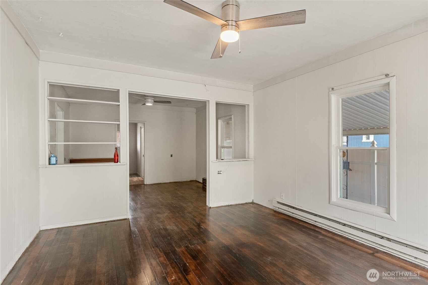 800 East Locust Street Waterville, WA 98858 - Photo 5 of 26 an empty room with wooden floor cabinet and windows