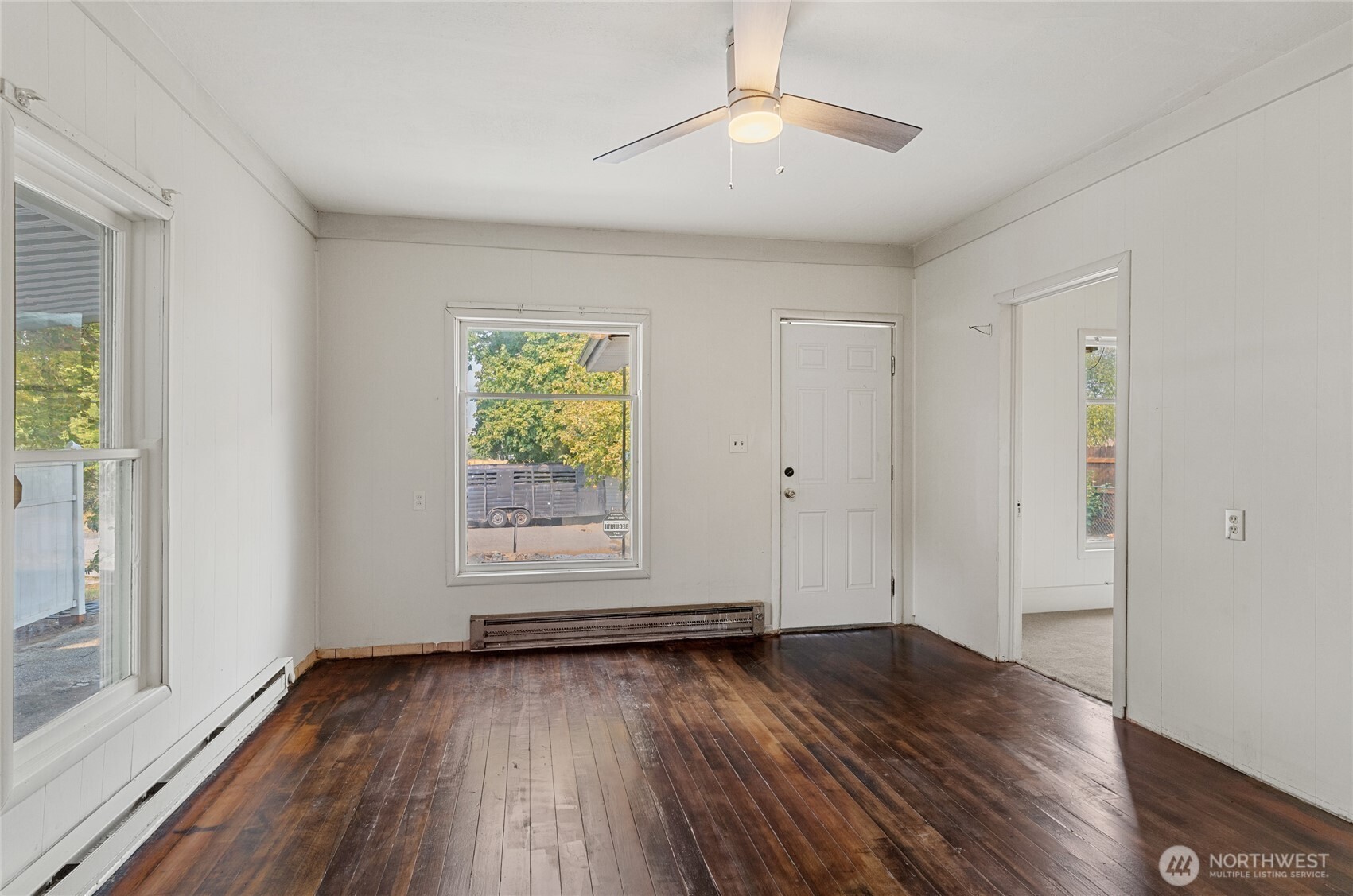 800 East Locust Street Waterville, WA 98858 - Photo 8 of 26 an empty room with wooden floor chandelier fan and windows