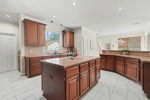 a kitchen with stainless steel appliances granite countertop a sink counter space cabinets and a large window