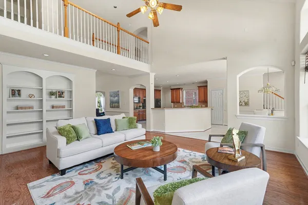 a living room with furniture and a chandelier