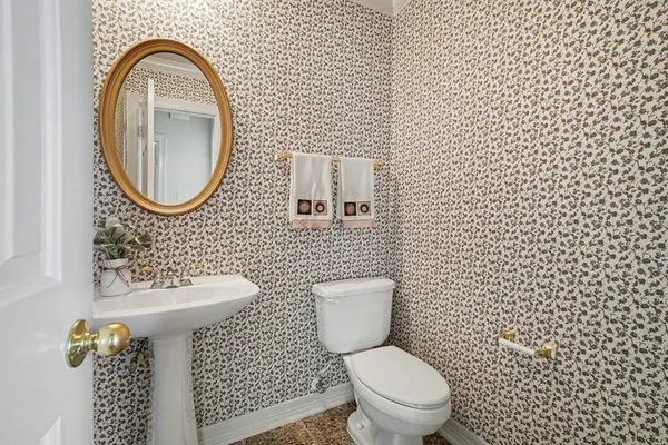 a bathroom with a sink a toilet and a mirror