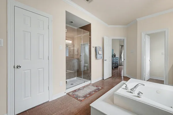 a bathroom with a tub sink and shower