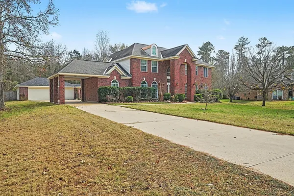 a front view of house with yard and green space