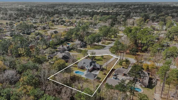 an aerial view of a house with a yard