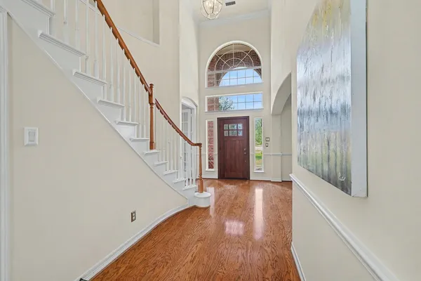 a view of entryway and hall with wooden floor