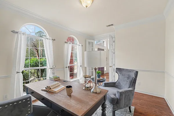 a view of a workspace with furniture and a window