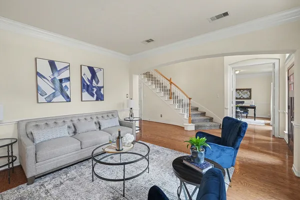 a living room with furniture and wooden floor