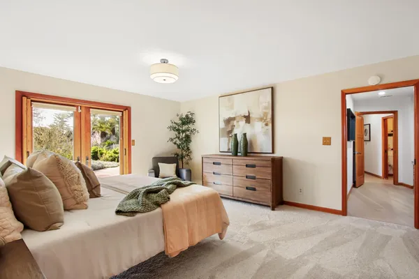 a bedroom with a bed and glass windows