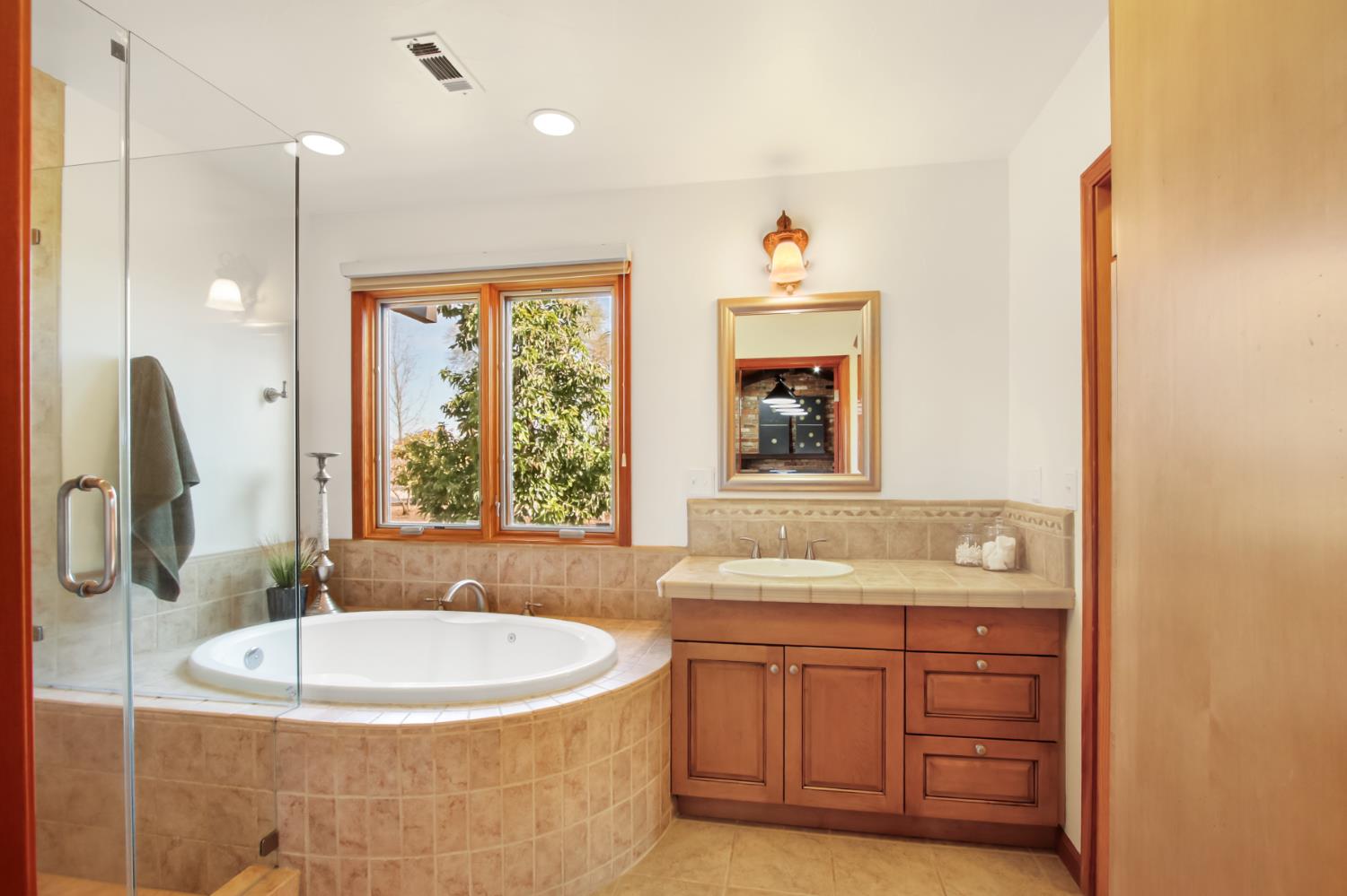 38385 Larue Way Davis, CA 95616 - Photo 46 of 89 a bathroom with a tub sink and mirror