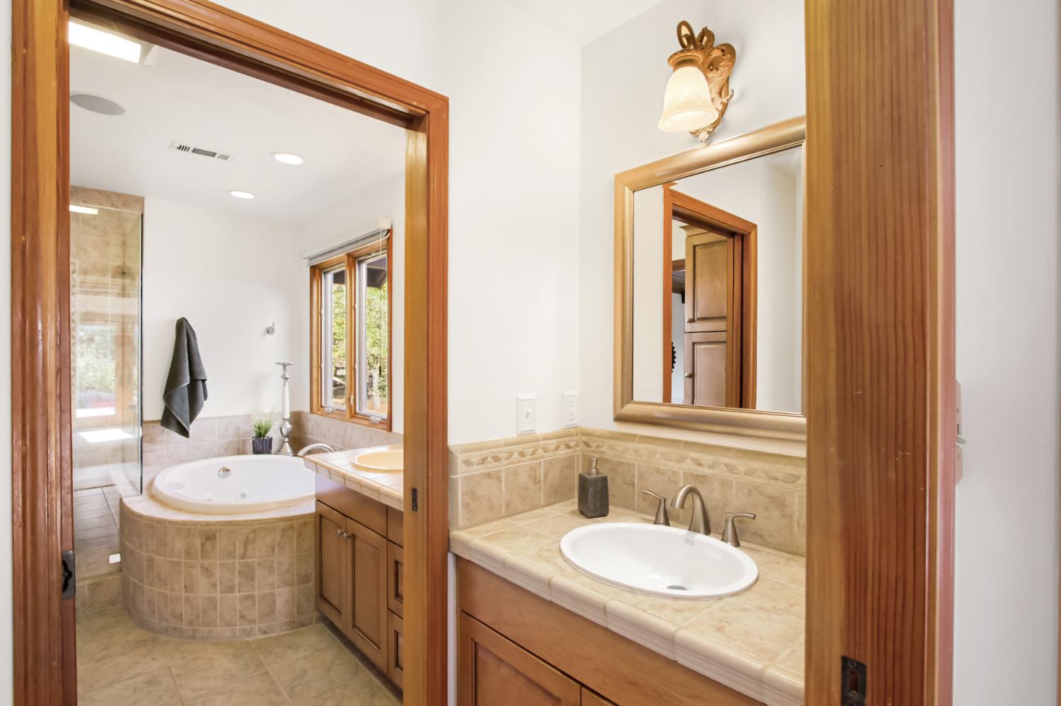 38385 Larue Way Davis, CA 95616 - Photo 47 of 89 a bathroom with a granite countertop sink and a mirror