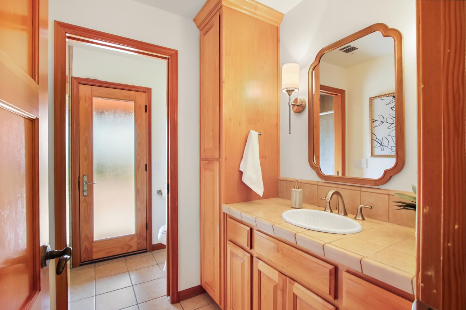 38385 Larue Way Davis, CA 95616 - Photo 51 of 89 a bathroom with a granite countertop sink and a mirror