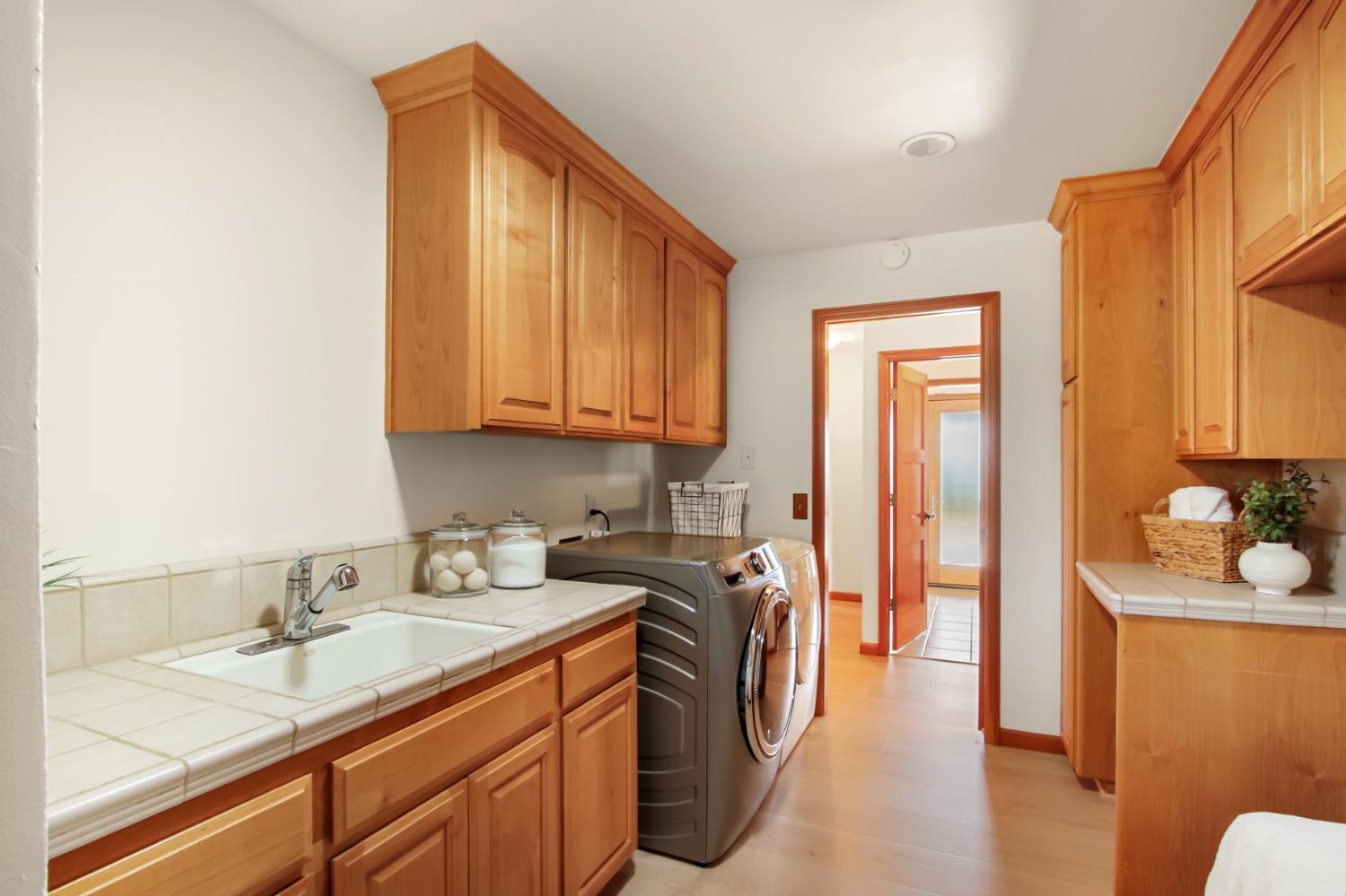 38385 Larue Way Davis, CA 95616 - Photo 56 of 89 a en suite bathroom with a granite countertop sink and a washing machine