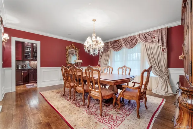 a view of a dining room with furniture wooden floor and a chandelier