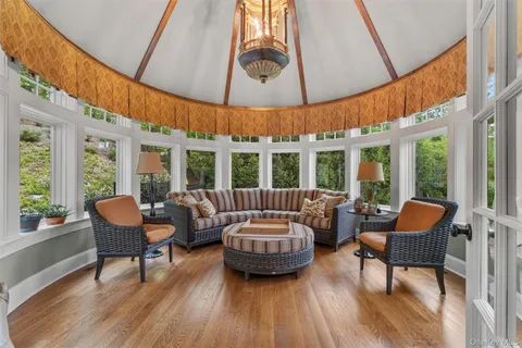 a living room with furniture a table and chairs