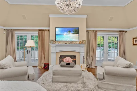 a living room with furniture a fireplace and a flat screen tv